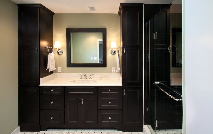 a bathroom with a sink, mirror and shower stall