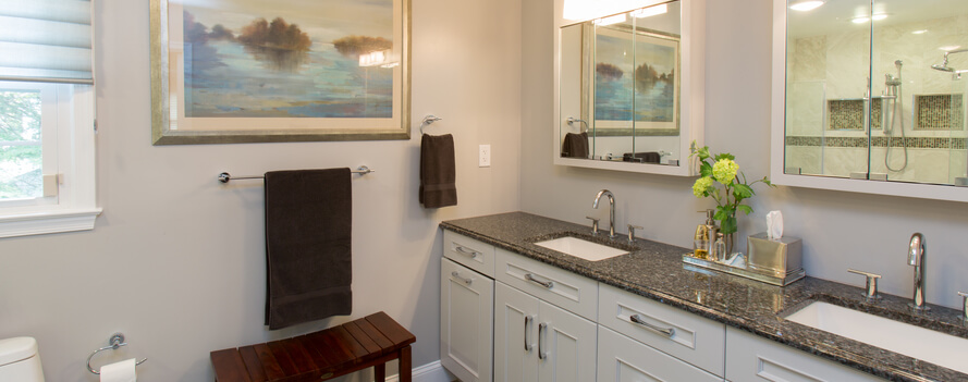 a bathroom with two sinks and a large painting