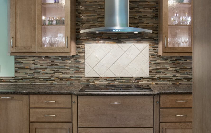 a kitchen with wooden cabinets and tile backsplash
