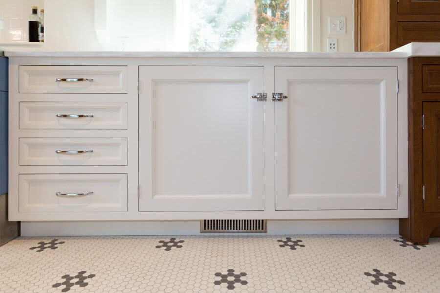 White cabinets below a kitchen sink