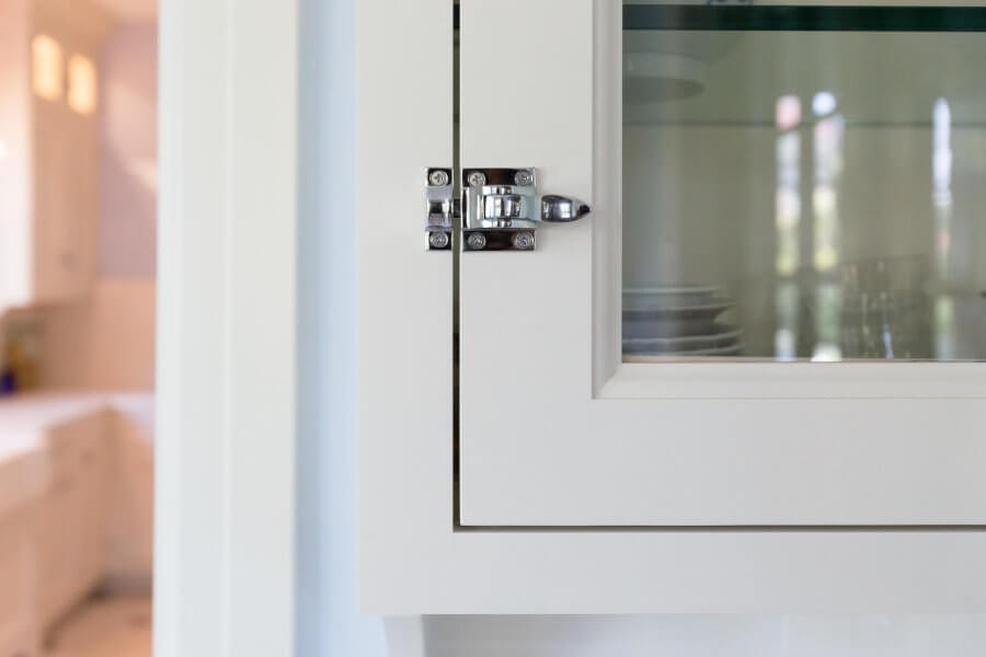 a white cabinet with a glass door on it