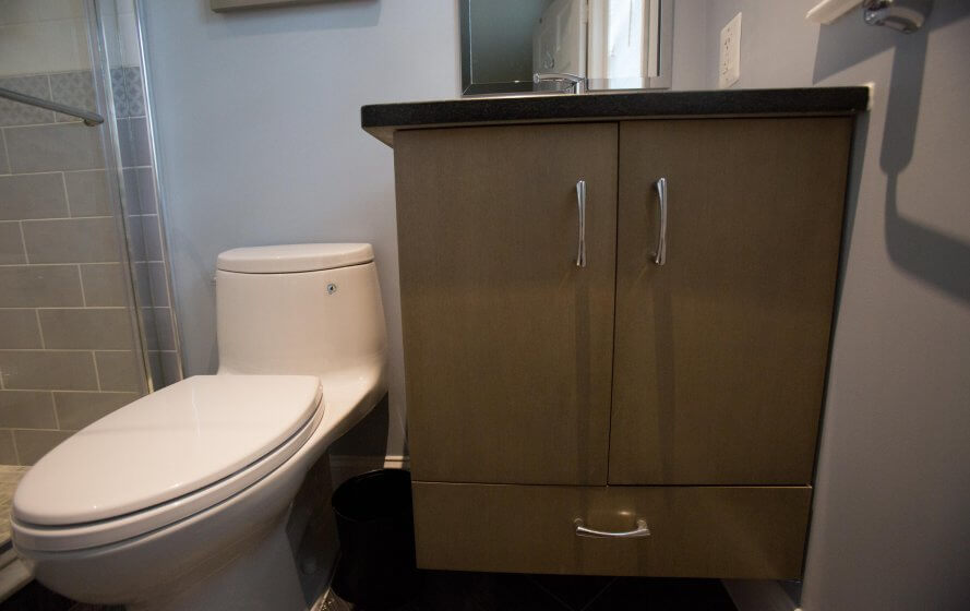 a bathroom with a toilet and a cabinet in it