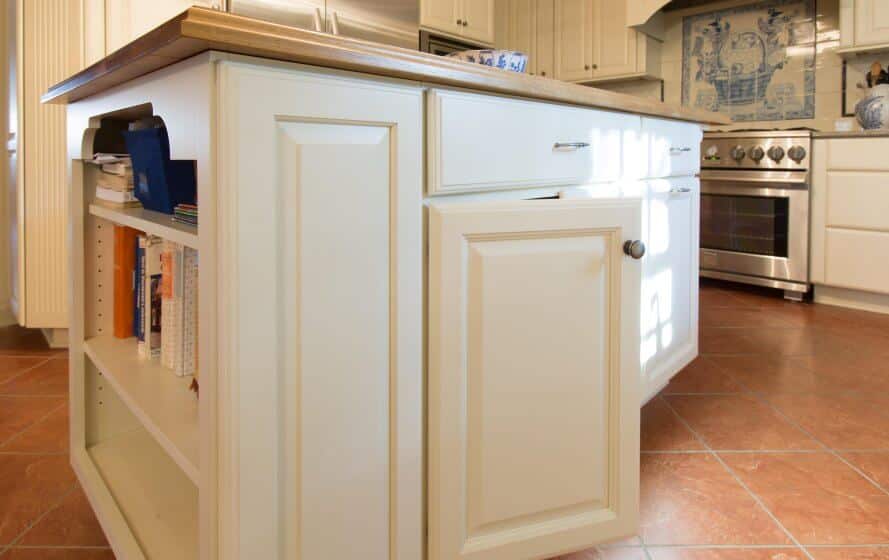 a kitchen with a stove, sink and cabinets