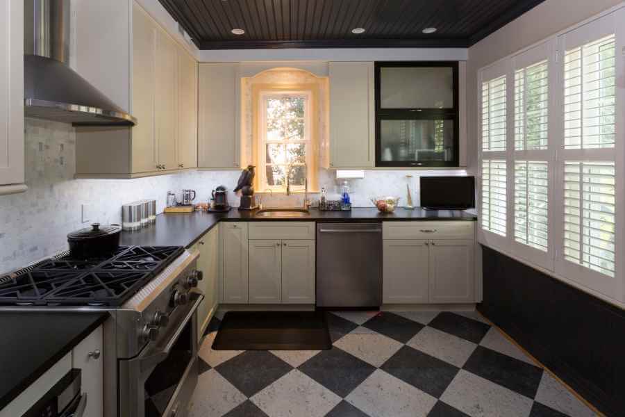 a kitchen with black and white checkered flooring