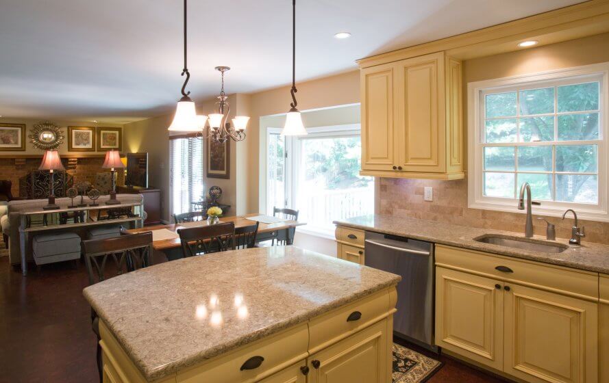 a large kitchen with a center island in the middle