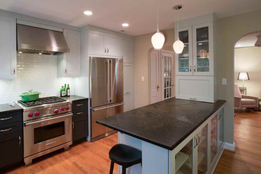 a kitchen with stainless steel appliances and wood floors
