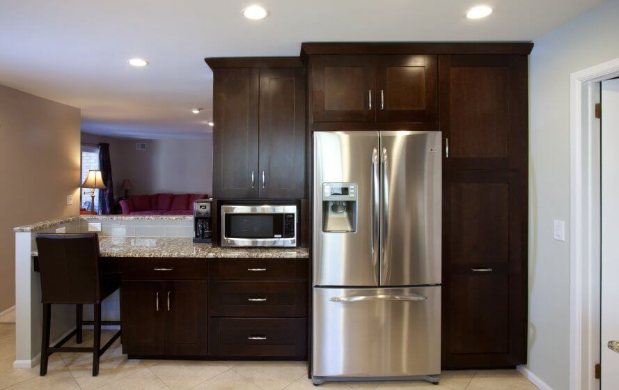 a stainless steel refrigerator and microwave in a kitchen
