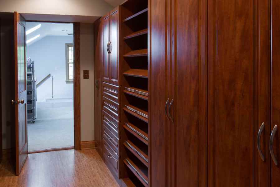 a large wooden closet with many drawers