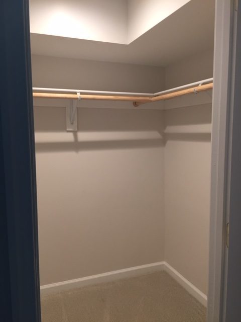 an empty closet with a light on the ceiling