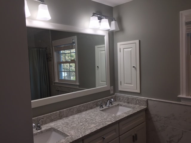 a bathroom with two sinks and a large mirror