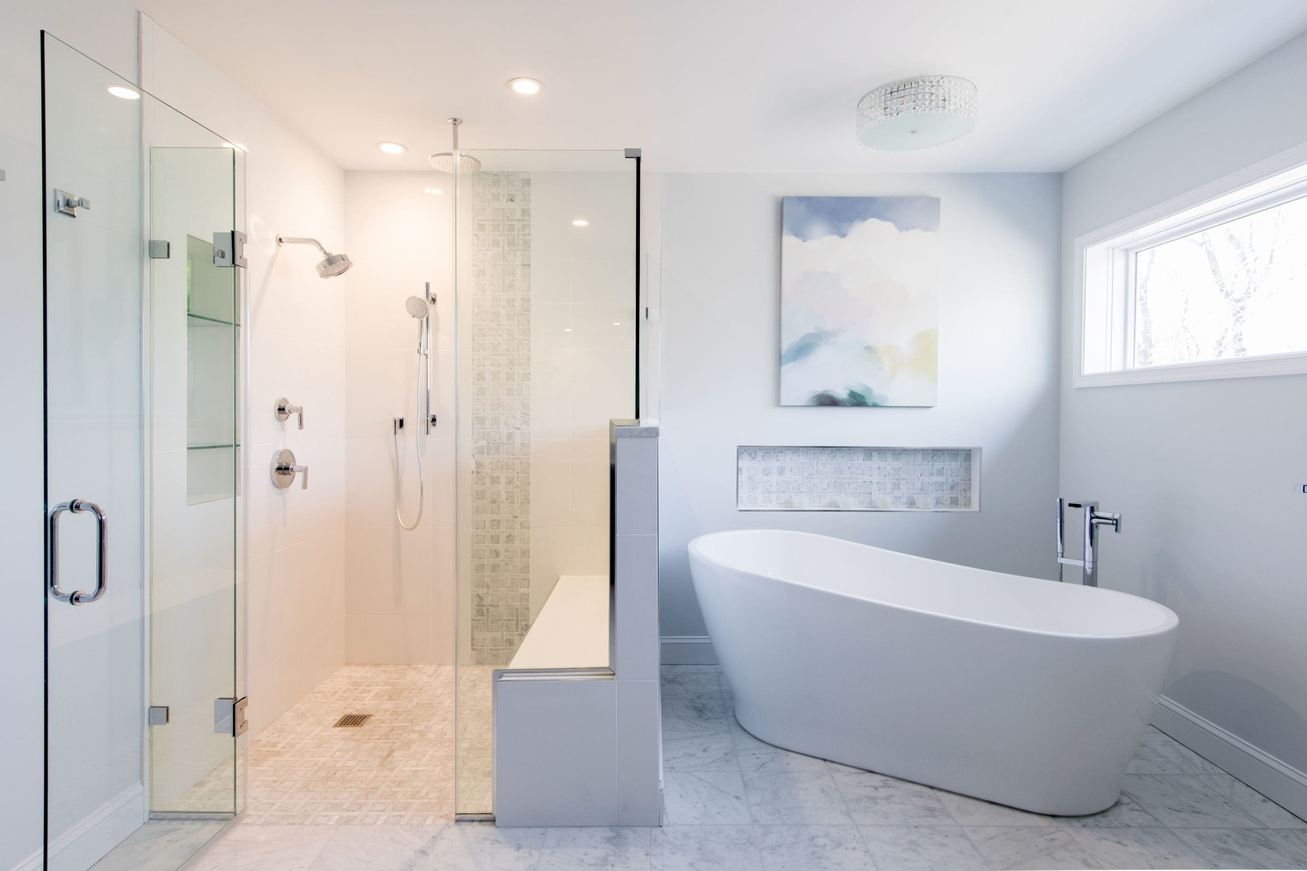 a modern bathroom with bright bathtub and glass shower with bench