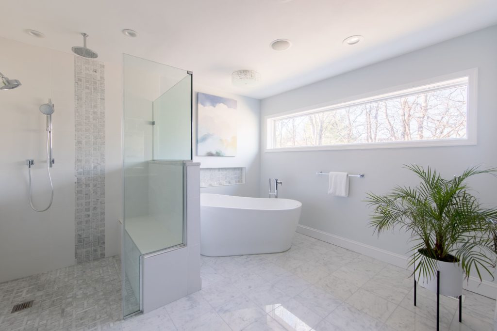 Light and bright remodeled bathroom with soak-in tub and separate stand-in shower