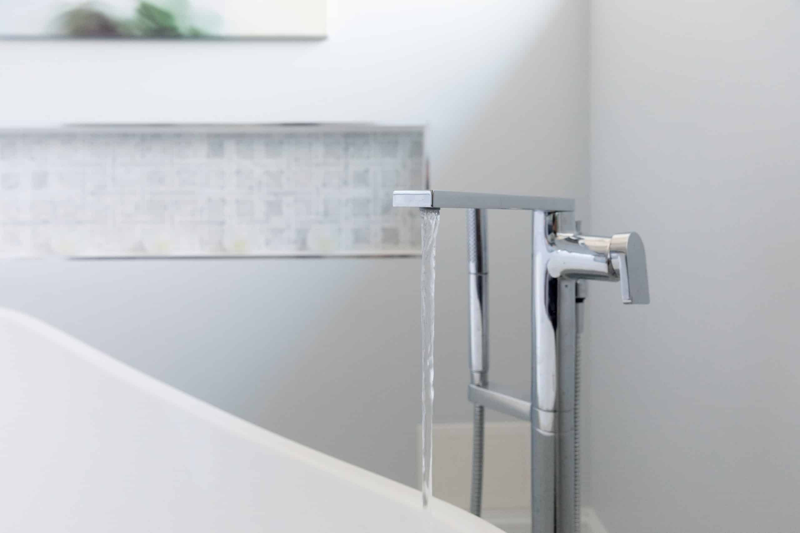 a bathroom with a modern bathtub and sleek stainless steel faucet