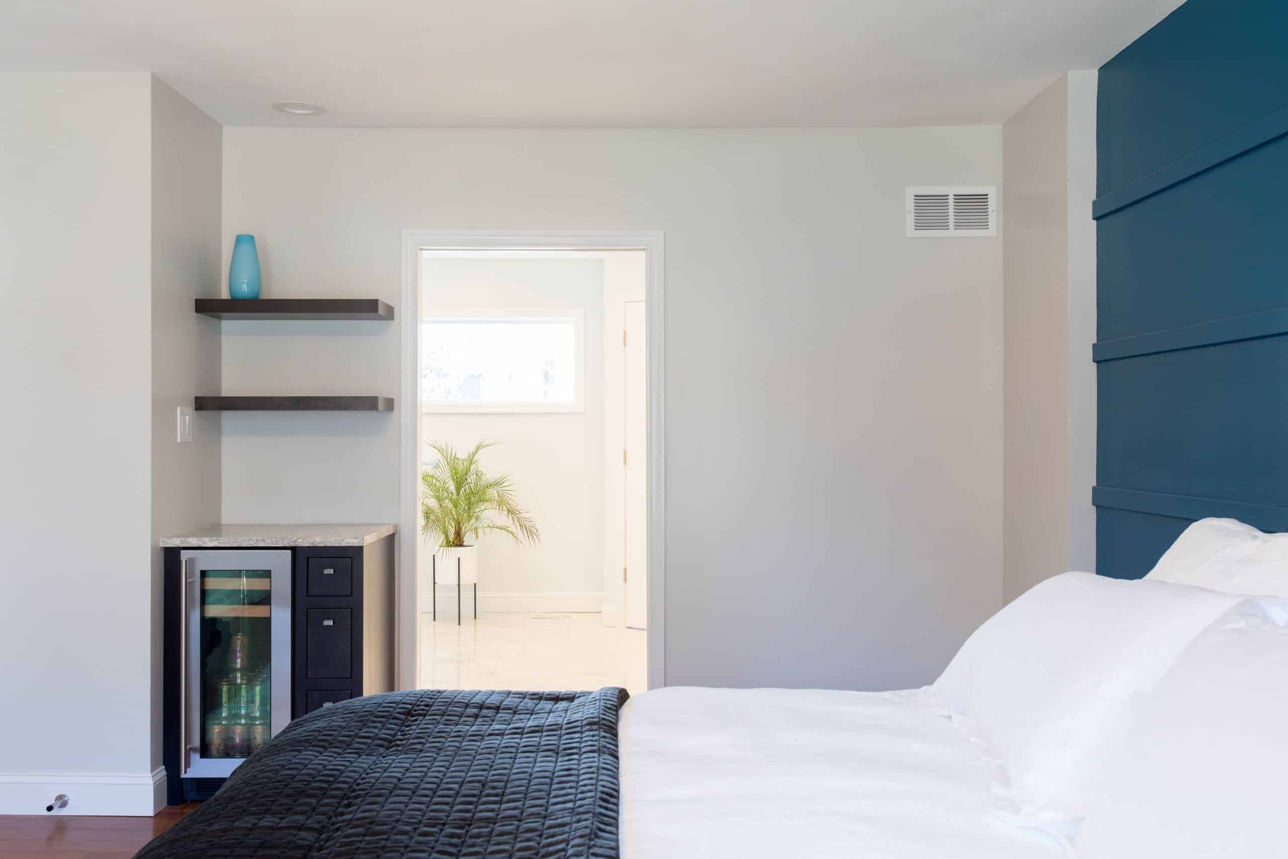 a bedroom with a bed and a blue wall