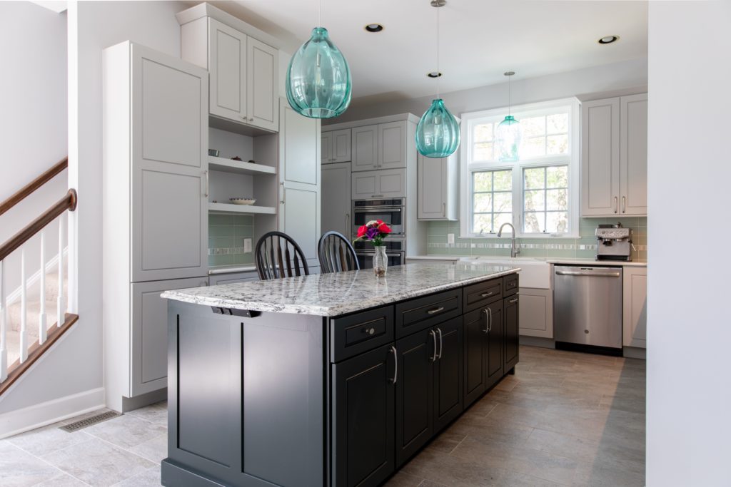 kitchen island with hanging pendant lights in a newly renovated kitchen