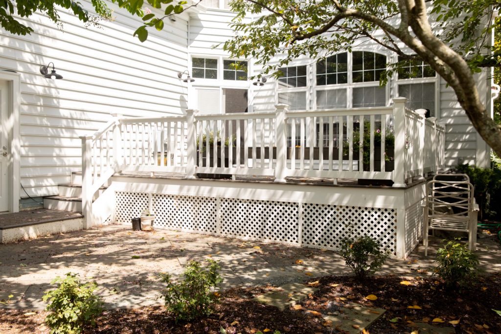 a white house with a porch and stairs in Rockville MD