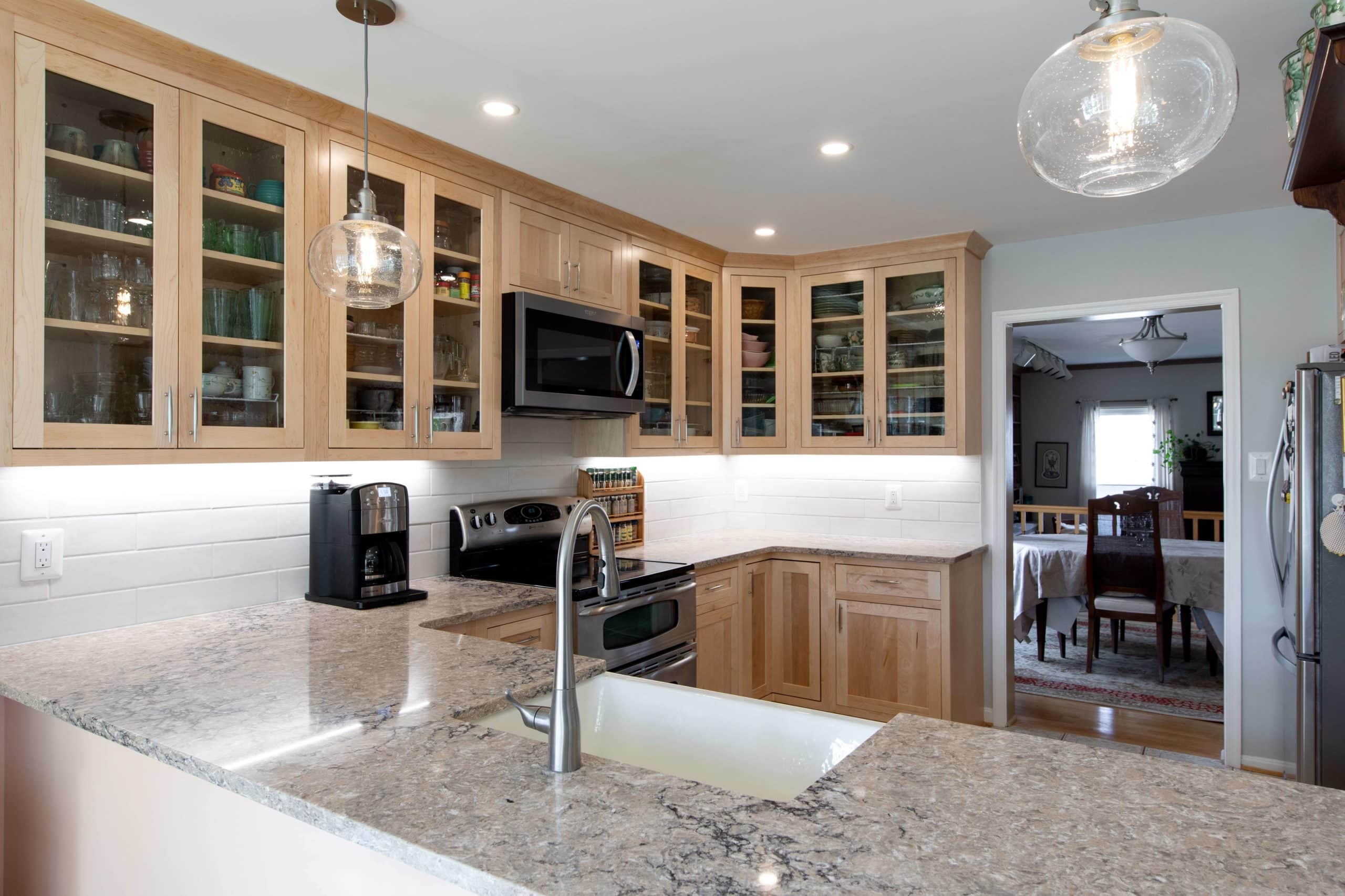 a kitchen with granite counter tops and wooden cabinets