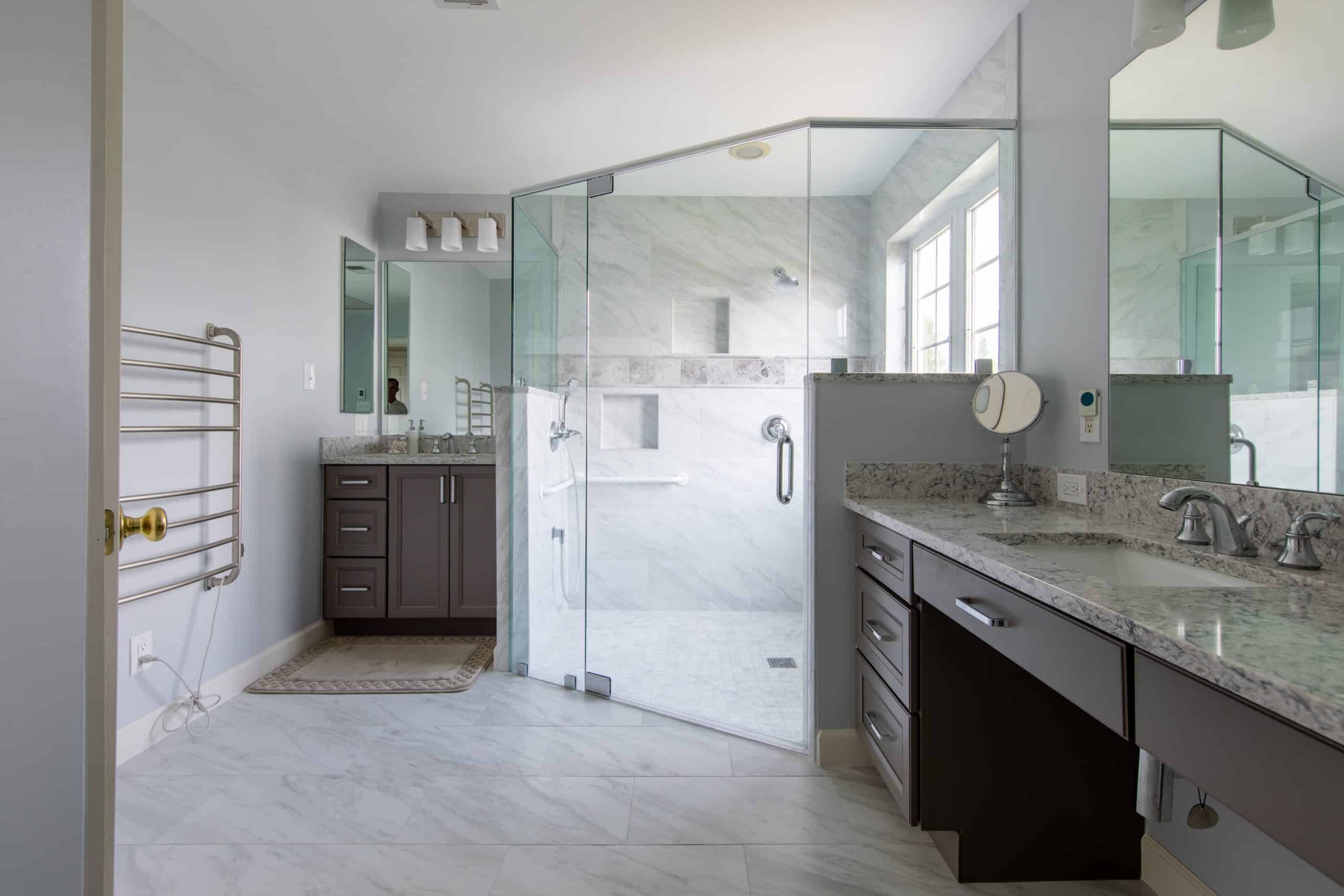 Remodeled bathroom with glass stand-in shower and large open space.