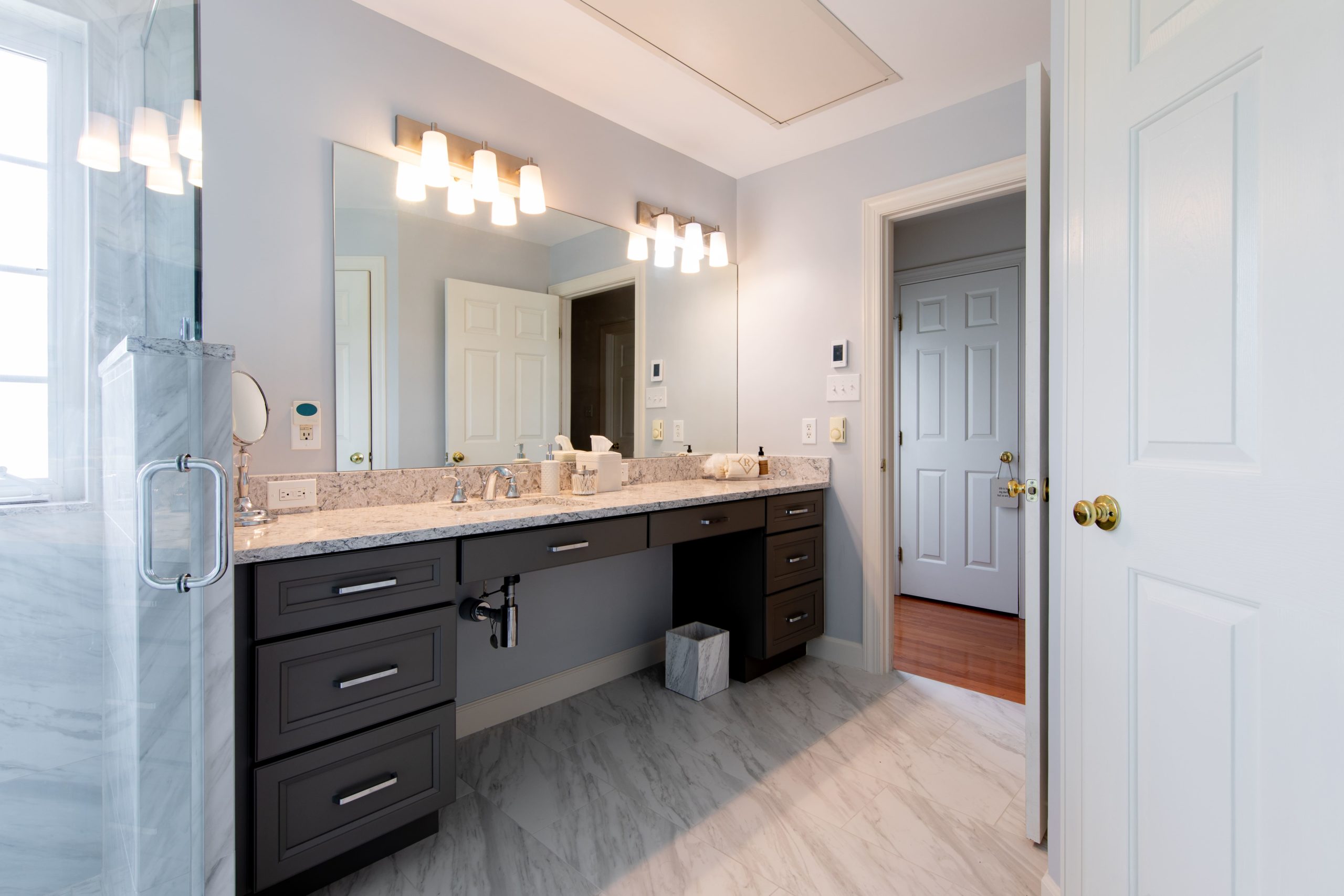 a large bathroom with spacious vanity and large mirror