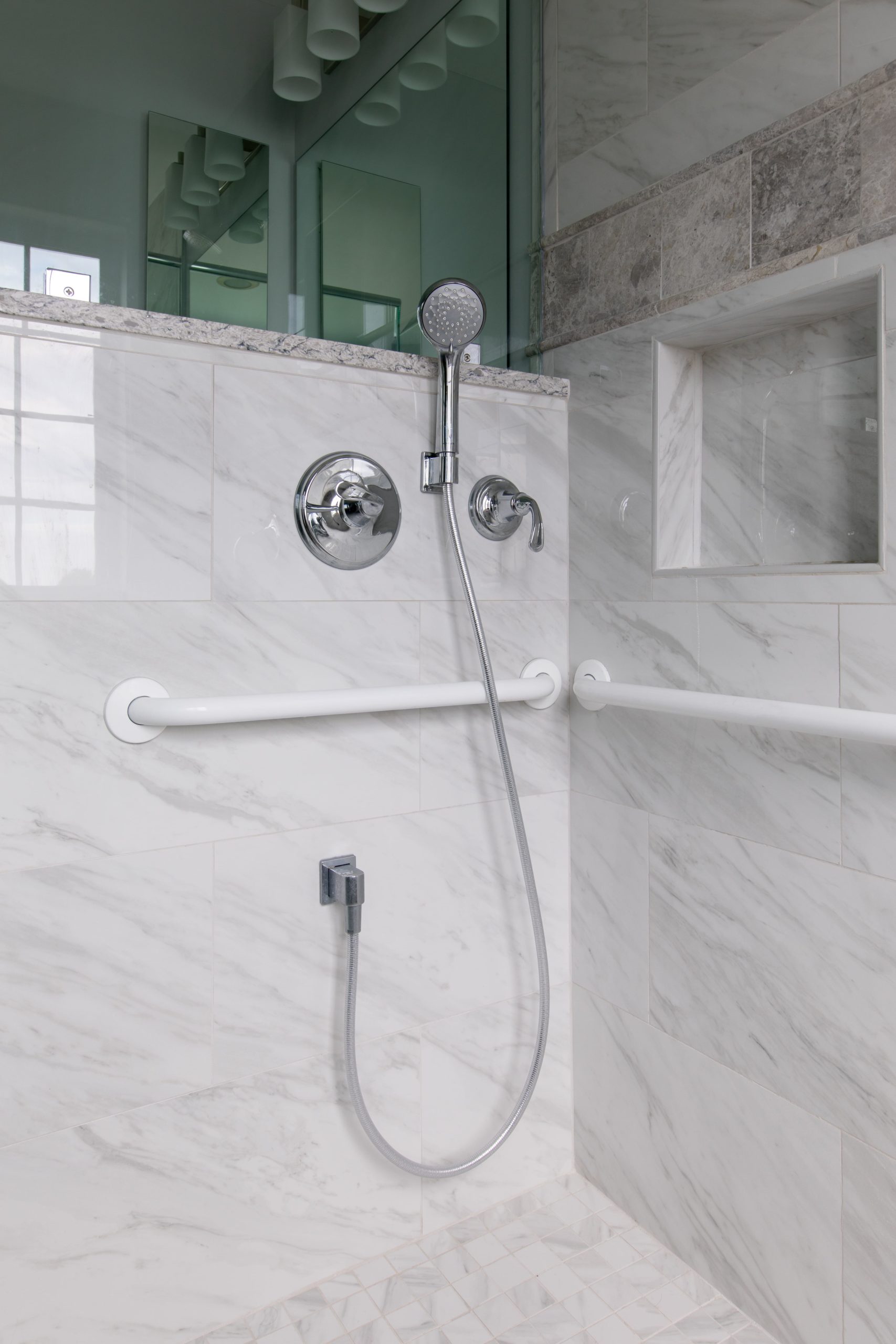 accessible shower with hand rails and handheld showerhead