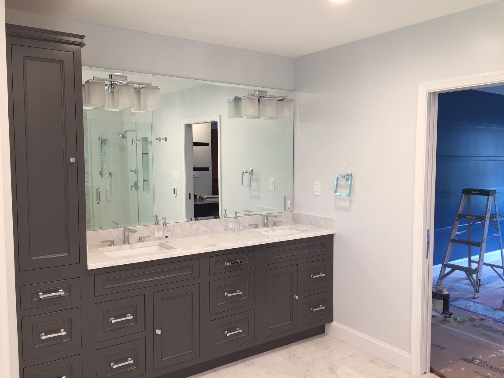 a large bathroom with double sinks and mirrors