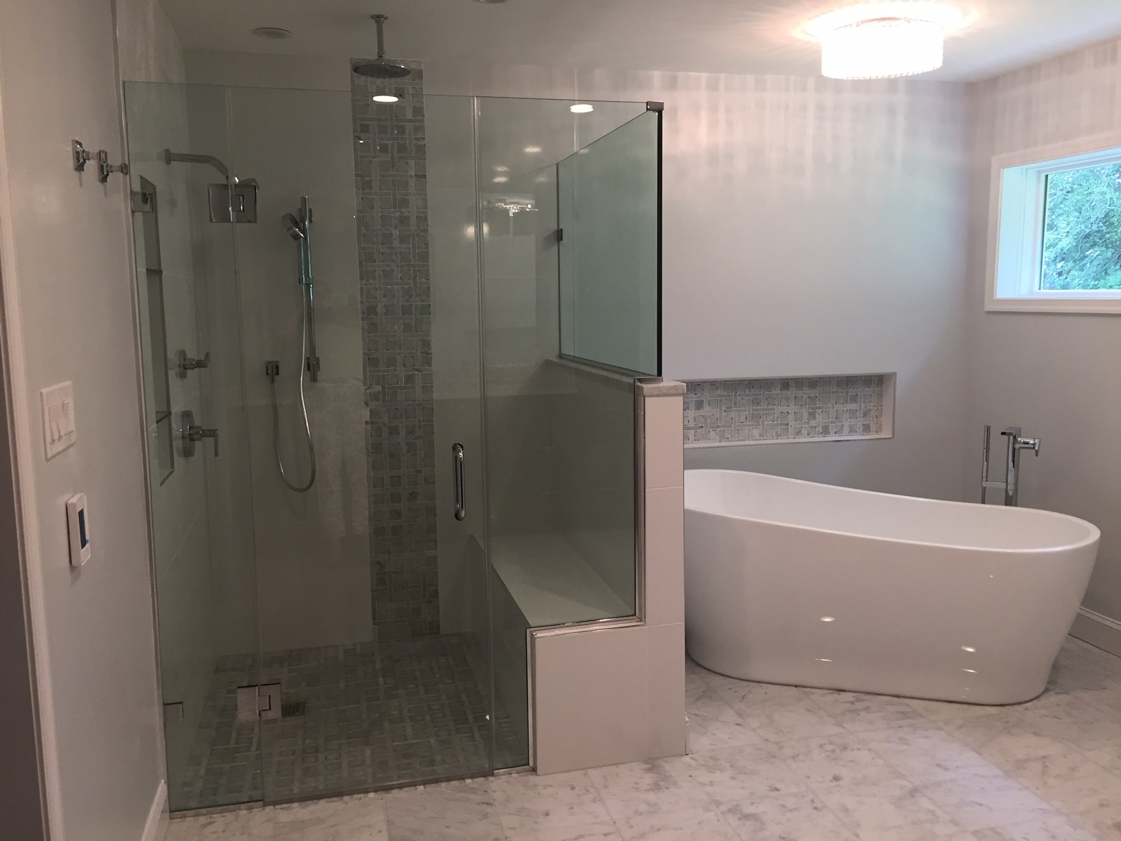 a bathroom with a bathtub, shower and sink