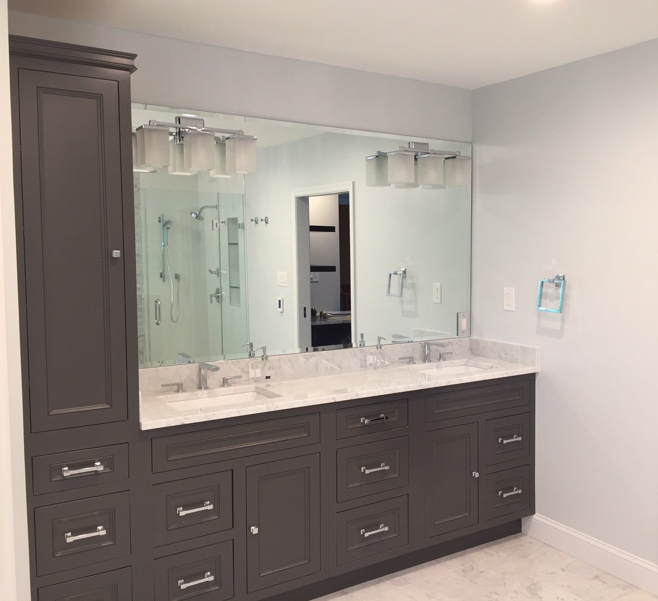 a large bathroom with double sinks and mirrors